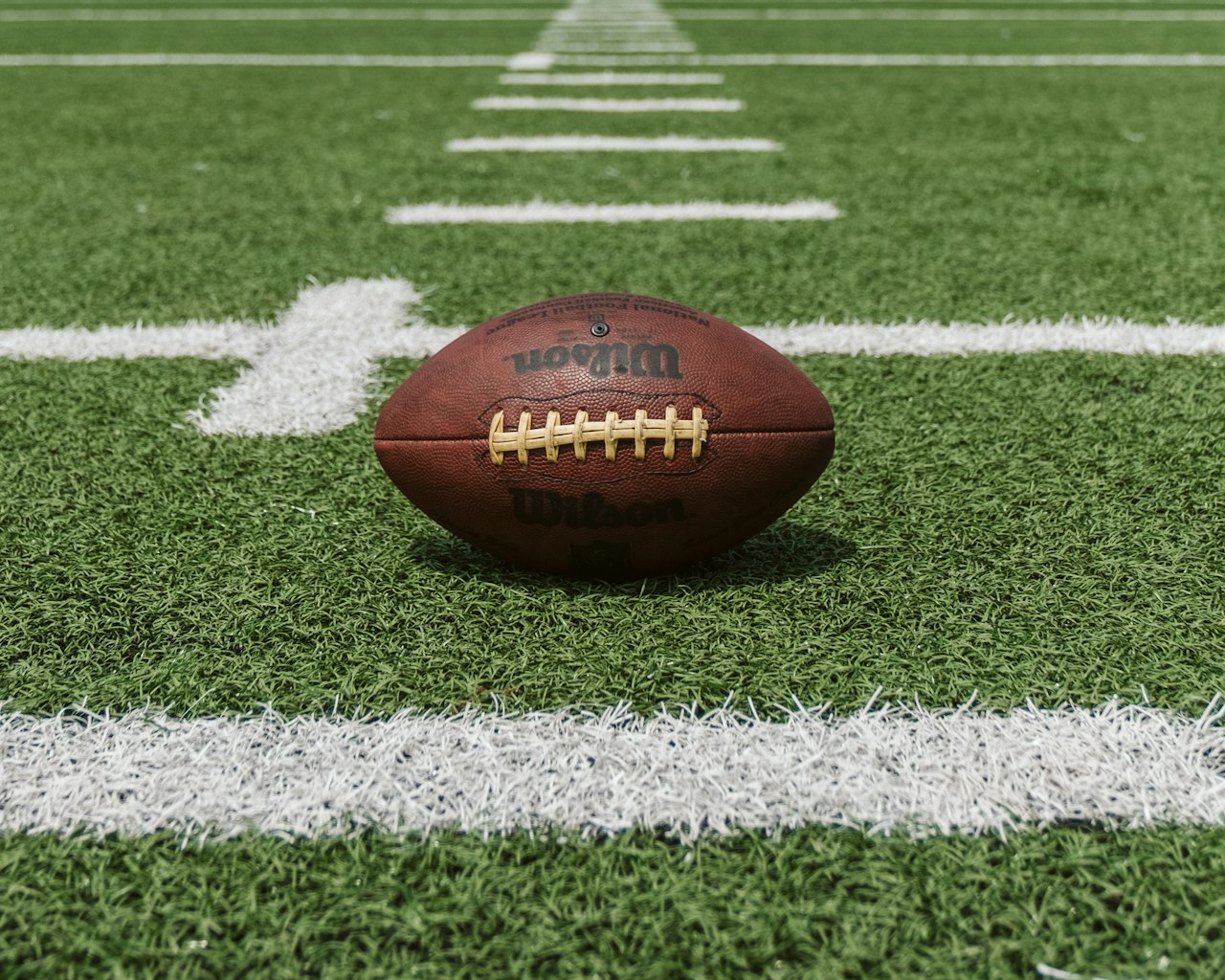 A football on the field, the framework lived in play, not posted on a wall.